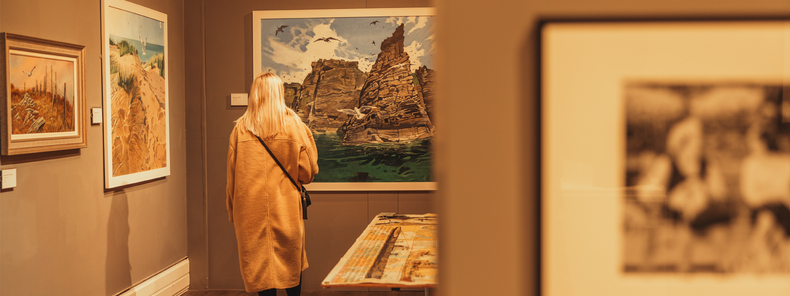 Young woman walking around the House of Manannan, looking at exhibits displayed about the Isle of Man