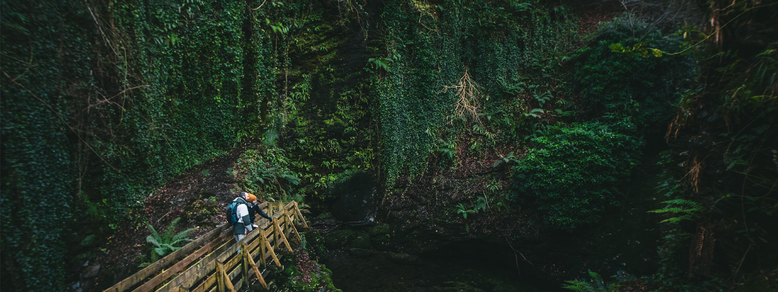 Two people on a bridge admiring the surroundings in Glen Maye