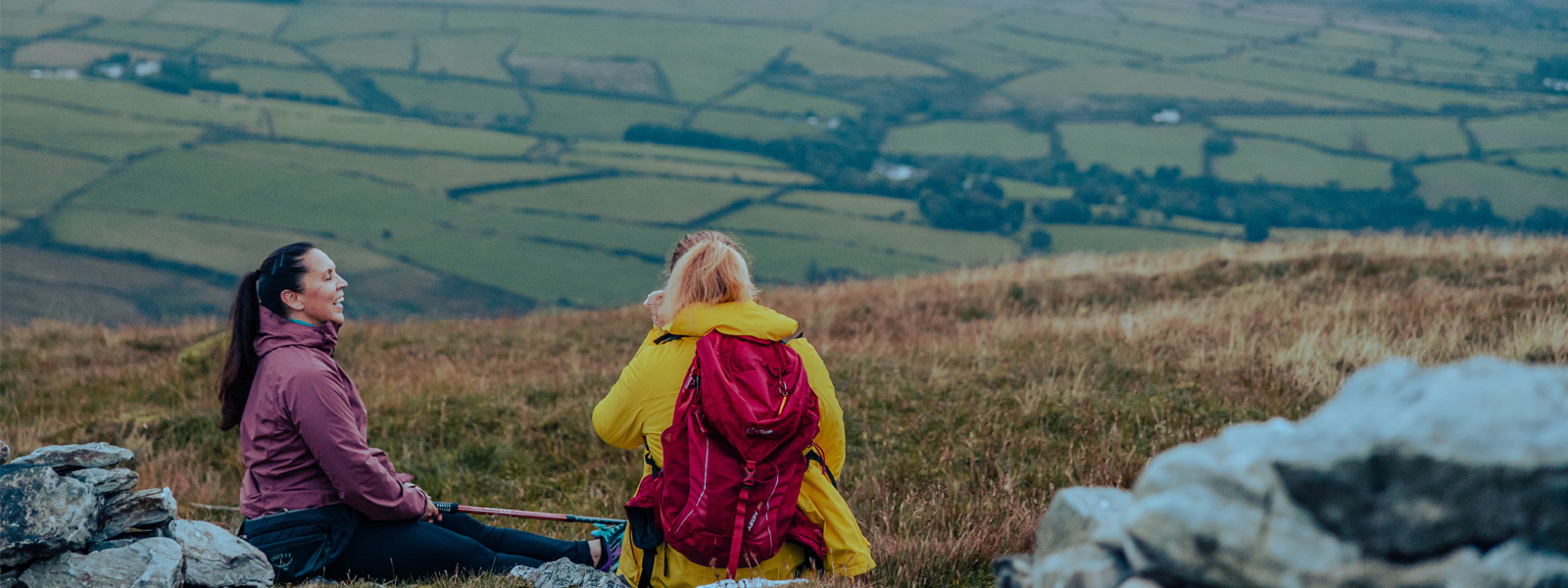 Two walkers sat at the top of Snaefell admiring the views