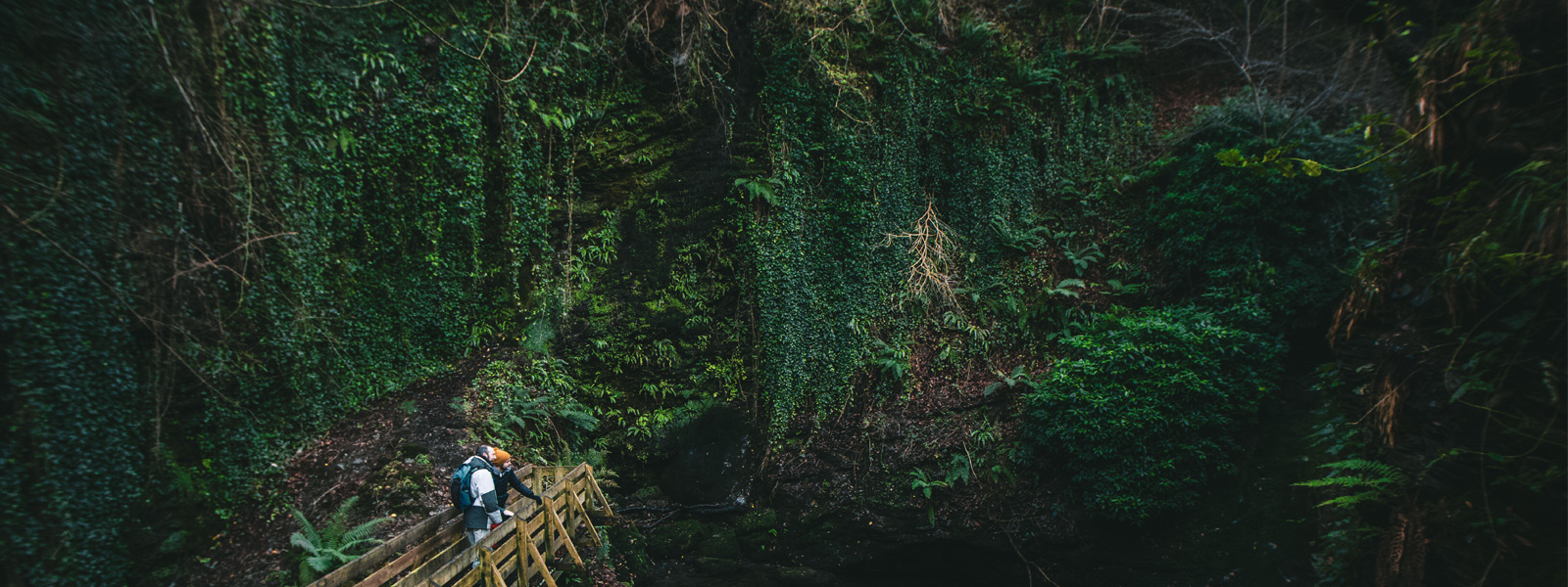 Two men stood on a bridge in the beautiful Glen Maye 