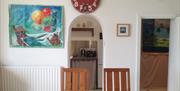 Chapel Bay Lodge lounge and dining area, leading through to kitchen and hallway to bedroom and bathroom