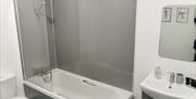 Bathroom with over shower bath