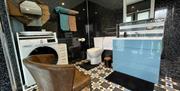A large bathroom with laundry washer/dryer facility