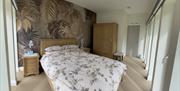 A luxury bedroom for total comfort. The narrow doors allow access to the outside so you can listen to the river run by.