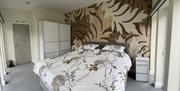 This super-king bedroom looks out on to the orchard and Barrule hills. Open the bedroom doors and listen to the birds singing