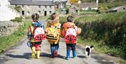Children wearing the Bee Explorer Bags at Cregneash